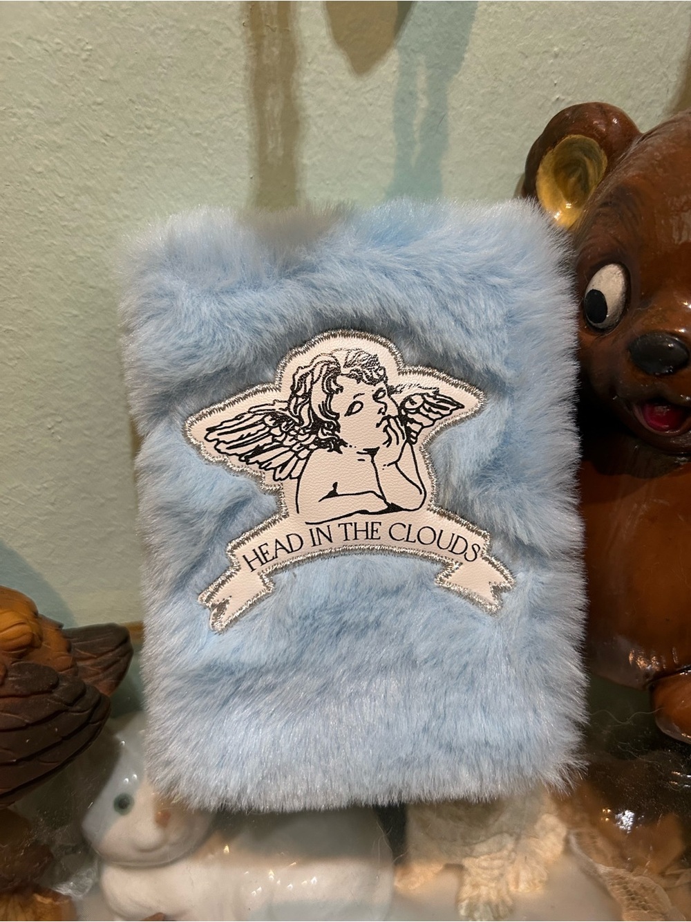 Blue fuzzy mini notebook with angel patch